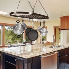 an island with pots and pans hanging from it