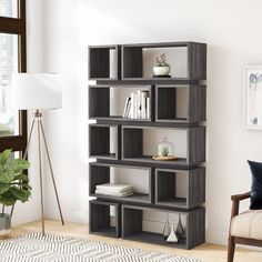 a living room with a chair and a book shelf in it's center area