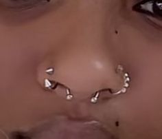 a woman with piercings on her nose