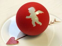 a red ball with a white silhouette of a child on it sitting on a plate