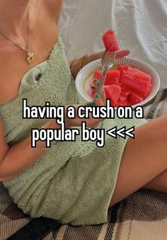 a woman in a towel holding a plate with watermelon slices on it and the words having a crush on a popular boy