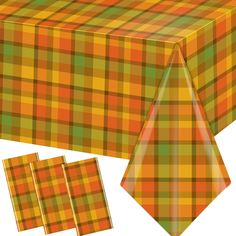 an orange and green plaid tablecloth with matching napkins