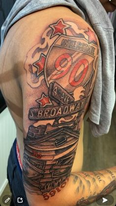 the back of a man's arm with an old school style sign and stars on it