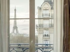 an open window overlooking the eiffel tower in paris