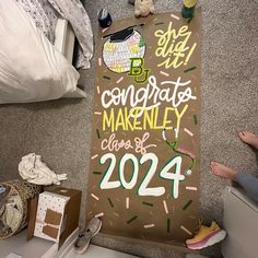 there is a sign that says congratulations makeley class of 202 on the floor next to some shoes