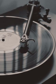 an old record player is playing music on the turntable