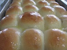 bread rolls are lined up in a metal pan