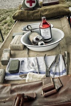 an outdoor picnic table is set up with personal care items and medical supplies on it