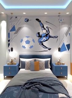 a bedroom with a soccer theme painted on the wall and a bed in front of it