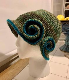 a crocheted hat with two spirals on the front and one at the back