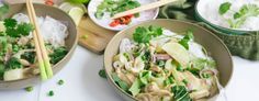 two bowls filled with food and chopsticks on top of a table