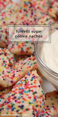 some sugar cookies with sprinkles and a bowl of cream on the side