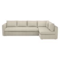 a white sectional couch sitting on top of a white floor