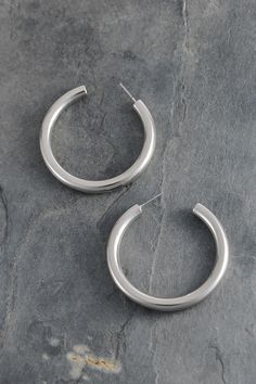 Add a touch of shine with our round hoop earrings! Available in silver or gold with a high polish finish, these 1.75" hoops are lightweight for all-day comfort. Perfectly pairs with any outfit - from puff hem dresses to shorts or maxis. Lead and nickel compliant with double E-coating to prevent tarnishing. Elegant Round Hoop Earrings For Spring, Everyday Metal Hoop Earrings For Summer, Chic Small Hoop Earrings For Spring, Everyday Summer Metal Hoop Earrings, Modern Everyday Jewelry For Spring, Modern Metal Hoop Earrings For Summer, Nickel Free Hoop Earrings For Spring, Nickel-free Hoop Earrings For Spring, Silver Hoop Earrings For Spring