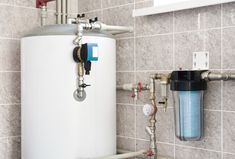 a water heater is shown with pipes and valves on the wall next to it