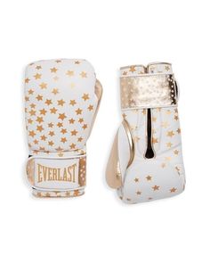 a pair of white boxing gloves with gold stars on the front and back of them