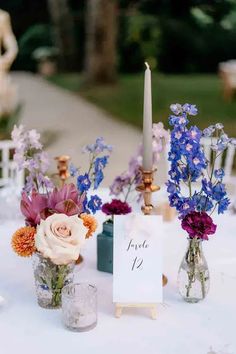 a table topped with vases filled with flowers