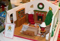 a doll house with furniture and decorations on display