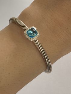 Size medium ideal for 7 inch wrist Pre Owned Excellent Condition Item cleaned and polished 100% Authentic David Yurman Albion Blue Topaz Bracelet 925 Sterling Silver 4mm BLUE Topaz 7mmx7mm Diamonds: Pave Setting Estimated 0.17ct Luxury Blue Sterling Silver Bracelet For Formal Occasions, Classic Blue Sterling Silver Bracelets, Luxury Blue Sterling Silver Round Bracelet, Classic Blue Sterling Silver Bracelet, Luxury Blue Sterling Silver Bracelet, Classic Blue Sterling Silver Gemstone Bracelet, Classic Blue Gemstone Sterling Silver Bracelet, Elegant Blue Bracelet With Sterling Silver Clasp, Elegant Blue Bracelets With Sterling Silver Clasp