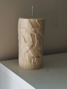 a candle that is sitting on a shelf