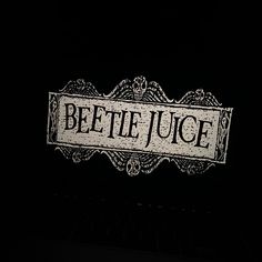 a black and white photo with the words beetlee juice on it's side