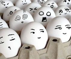 many eggs with faces drawn on them