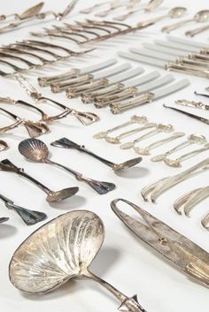 an assortment of silverware and spoons on display