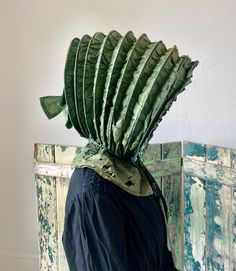 A delightful large antique calash bonnet. Green silk fabric over ribs with a semi-sheer lining and buckram at crown. Ruffle around face and a bow at the back of crown. Ten ribs including front brim. Collapsible bonnet that lays flat. Completely hand stitched. Fair condition with soiling, exposed ribs, fragile damaged neck apron, and fabric wear as seen in photos. Laying flat it measures 13" x 11" plus neck apron. Opened it is approximately 15" x 13" x 11". Dates to late 18th century to early 19t Green Silk Fabric, Hair Adornments, Current Fashion, Jane Eyre, Green Silk, Hat Hairstyles, Hand Stitched, Silk Fabric