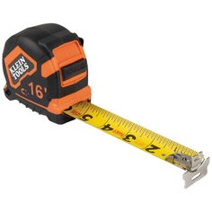 an orange and black tape measure is on a white background with a measuring ruler in the foreground