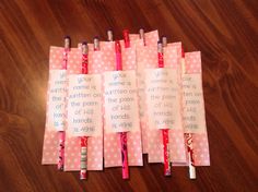 pink and white polka dot paper with writing on them next to some toothbrushes