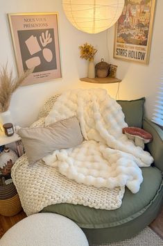 a bed with blankets and pillows on top of it in a room filled with furniture