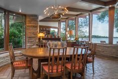 the dining room table is surrounded by wooden chairs