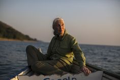 an old man sitting on the side of a boat