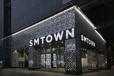 the entrance to smtown's store at night with its lights on and windows lit up