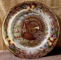 a plate with a turkey on it sitting on a table next to a brown cloth