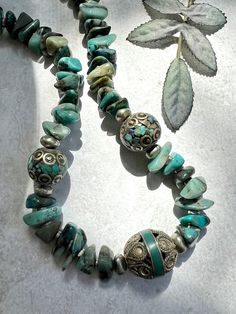 Gorgeous chunky goodness... 16" long Chrysoccola large, polished, chip shaped beads in a pattern with antique silver toned 3 sided disc spacers. I added stations of turquoise Tibetan mosaic focal beads flanked by silver nugget beads. Love the shades of aqua, turquoise, blue, green and brown. Strung on nylon with a lobster clasp. I can add an extension chain upon request for length adjustment. Beautiful statement piece. One of a kind. All of my pieces are created with great care, quality elements and attention to detail. I hope you are happy with your purchase and should you have any concerns or questions, please let me know. I am happy to help. Every item is handmade so please use care when wearing and storing. Please avoid wearing in the water and using oils, lotion and any chemicals so t Artisan Silver Turquoise Necklace With Spacer Beads, Adjustable Silver Turquoise Necklace With Large Beads, Artisan Silver Turquoise Necklace With Large Beads, Bohemian Silver Turquoise Necklace With Spacer Beads, Shades Of Aqua, Handmade Market, Focal Beads, Chunky Jewelry, Aqua Turquoise