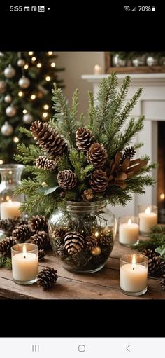 a table topped with candles and pine cones