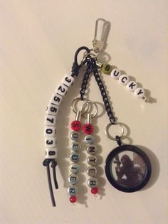 a keychain that has some charms attached to it with beads and letters on it