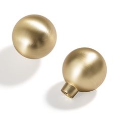 two shiny gold balls on a white background