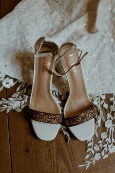 the bride's wedding shoes are sitting on the floor