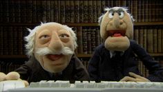 two puppets are sitting at a computer keyboard