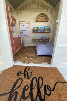 a door mat that says oh hello on the floor in front of a room with bookshelves