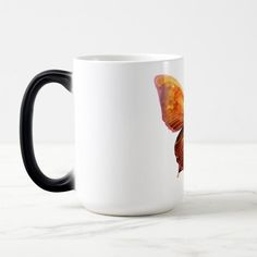 a coffee mug with an orange butterfly on it