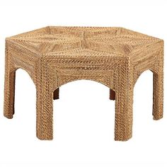 a wicker coffee table with an octagonal design on the top and bottom, made out of