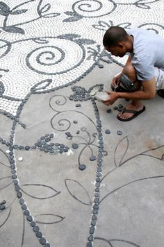 a young boy is working on a mosaic design