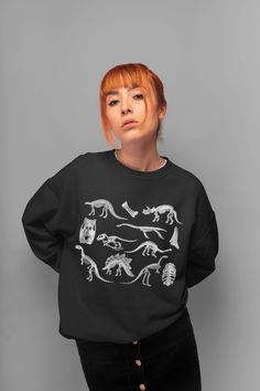 Dinosaur Sweatshirt Skeletons Sweater Goblincore Clothing Aesthetic Clothing Dark Academia Pullover Dino Sweatshirt Dino Crewneck Sweater. Sweatshirt features: *Made from 50% cotton, 50% polyester (heathers colors are 40% cotton, 60% polyester) *Medium-heavy fabric (8.0 oz/yd² (271.25 g/m *Loose fit *Oversized if you choose 1-2 sizes bigger *Sewn-in label *Runs true to size *Crewneck *Unisex style *Ribbed knit collar *Without itchy side seams Canvas Tote Bag features (available in black color): Winter Long Sleeve Tops With Dinosaur Print, Dinosaur Print Long Sleeve Tops For Winter, Long Sleeve Top With Dinosaur Print For Fall, Cotton Tops With Dinosaur Print For Fall, Cotton Top With Dinosaur Print For Fall, Casual Dinosaur Print Tops For Fall, Casual Dinosaur Print Crew Neck Sweatshirt, Winter Dinosaur Print Crew Neck Top, Casual Dinosaur Print Tops For Streetwear