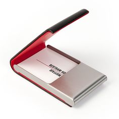 a red and silver business card holder with a black handle on the top, in front of a white background