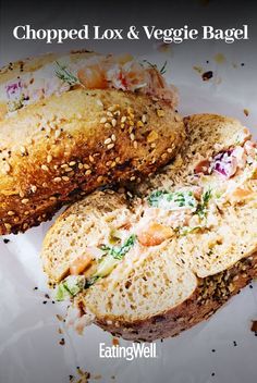 a close up of a bagel on a plate with the words chopped lox and veggie bagel