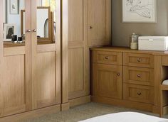 a bathroom with wooden cabinets and drawers