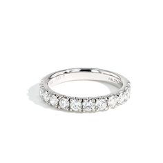 a white gold wedding band with five stones on the side and two rows of diamonds in the middle